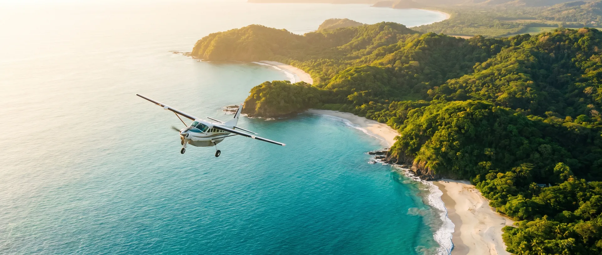 Aerial view of the Costa Rican Pacific coastline at golden hour with a small plane